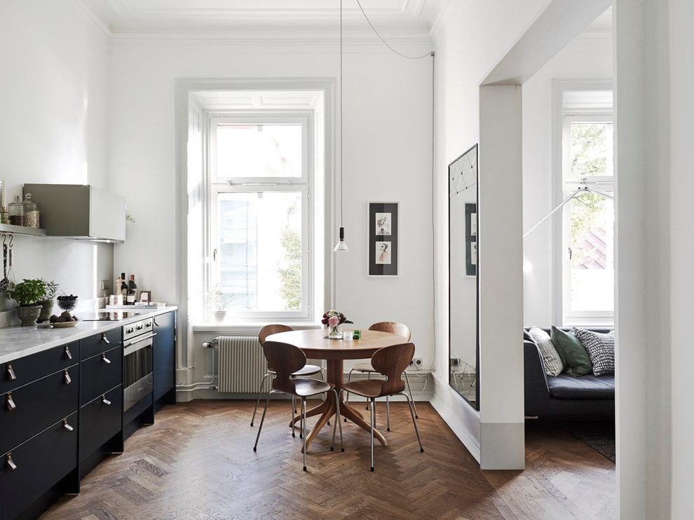 Mid-sized scandinavian kitchen/dining combo in Gothenburg with white walls, dark hardwood floors and no fireplace.