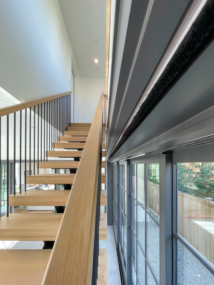 Expansive modern wood floating mixed railing staircase in DC Metro with tongue and groove walls.