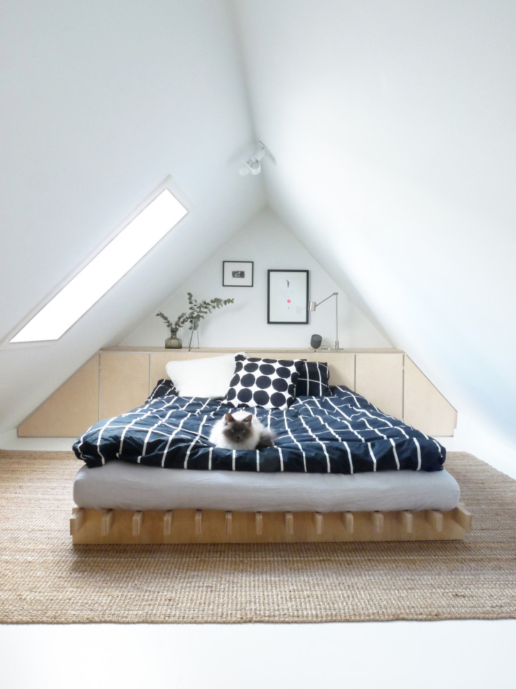 This is an example of a small contemporary bedroom in Copenhagen with white walls, carpet and white floor.