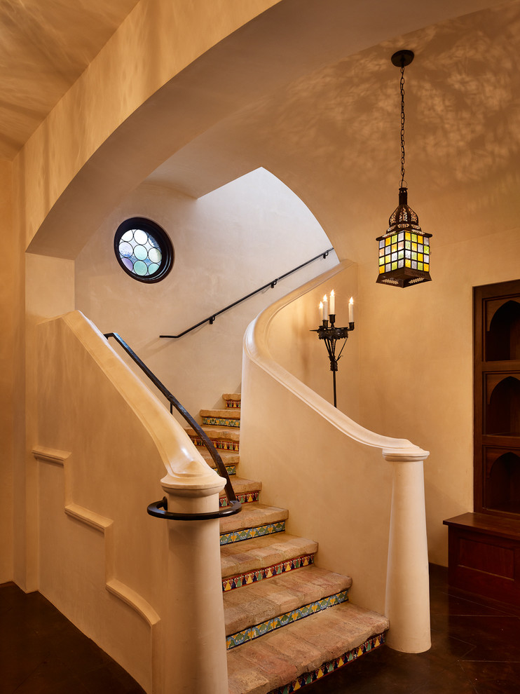 Inspiration for a mediterranean l-shaped staircase in Austin with tile risers.