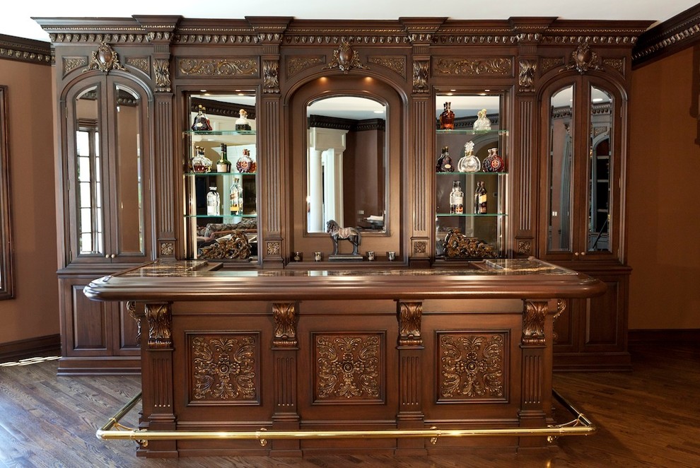 Design ideas for a mid-sized traditional home bar in New York with medium hardwood floors.