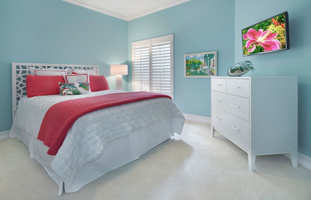 Design ideas for a mid-sized beach style guest bedroom with blue walls and carpet.