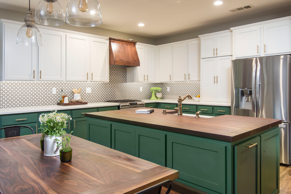 Inspiration for a large country l-shaped eat-in kitchen in Los Angeles with a farmhouse sink, shaker cabinets, green cabinets, quartz benchtops, multi-coloured splashback, porcelain splashback, stainless steel appliances, with island, brown floor and white benchtop.