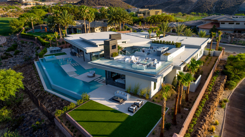Inspiration for a large contemporary one-storey white house exterior in Las Vegas with a flat roof.
