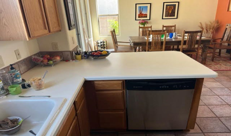 Inspiration for a mid-sized u-shaped kitchen remodel in Phoenix with raised-panel cabinets, medium tone wood cabinets, quartzite countertops, white backsplash, a peninsula and gray countertops