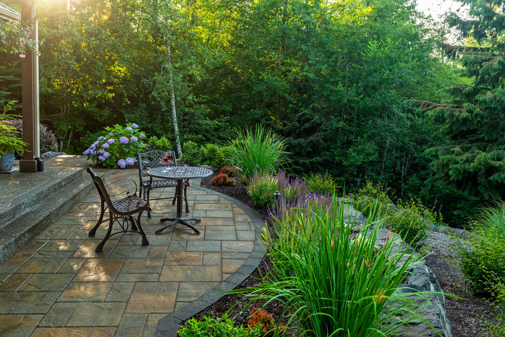 Expansive traditional back garden in Seattle with a waterfall and natural stone paving.