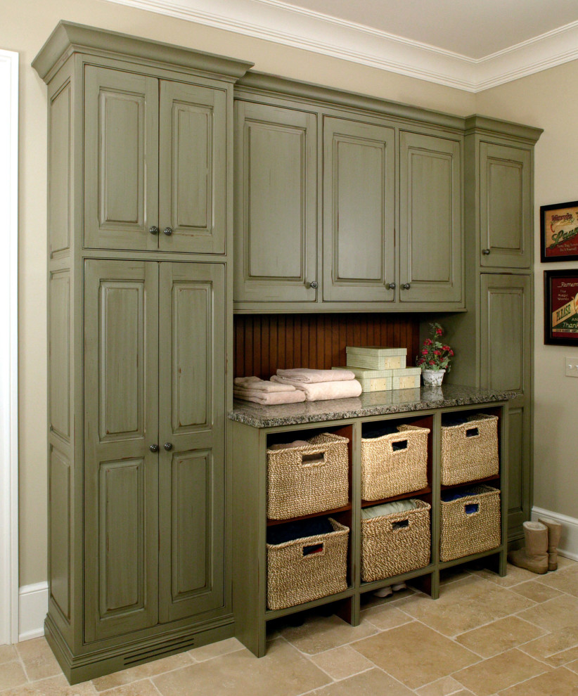Inspiration for a large traditional galley utility room in Chicago with raised-panel cabinets, green cabinets, granite benchtops, beige walls and travertine floors.