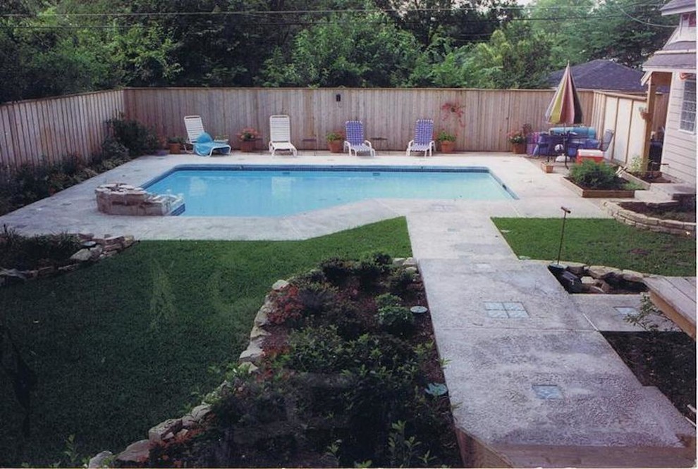 Design ideas for a small contemporary backyard custom-shaped natural pool in Dallas with a water feature and natural stone pavers.