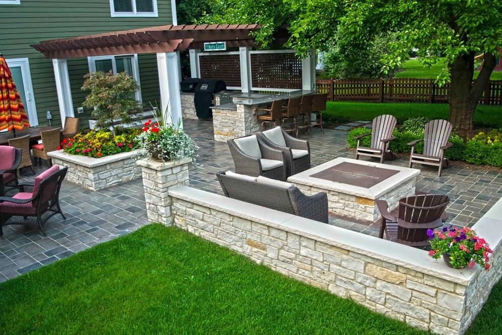 Large transitional backyard patio in Chicago with a fire feature, concrete pavers and a pergola.