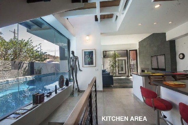 Example of a mid-sized trendy concrete floor kitchen design in Orange County with two islands