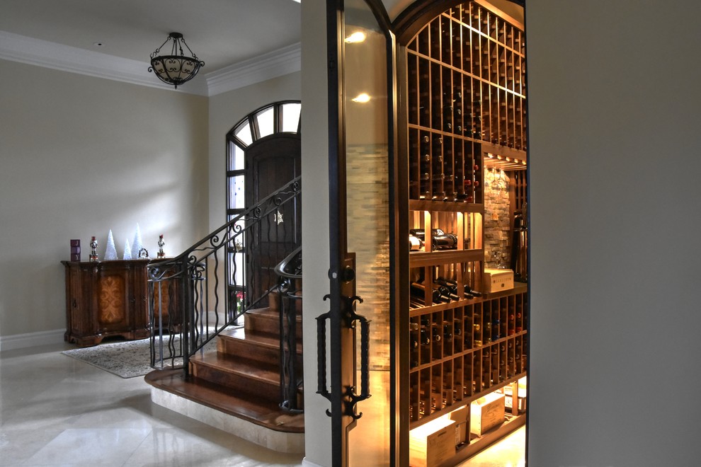 Photo of a mid-sized country wine cellar in San Diego with marble floors and display racks.
