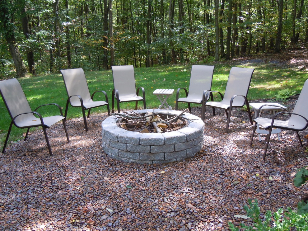 Photo of a large contemporary backyard patio in Other with natural stone pavers and no cover.