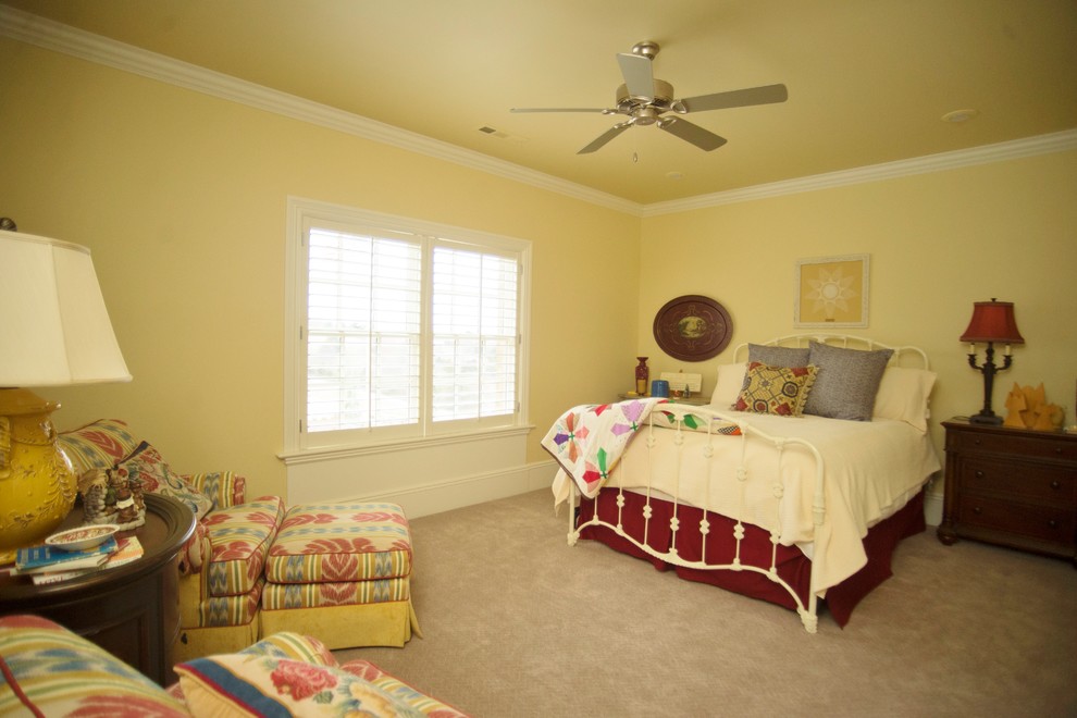 Design ideas for a mid-sized country guest bedroom in Other with yellow walls and carpet.