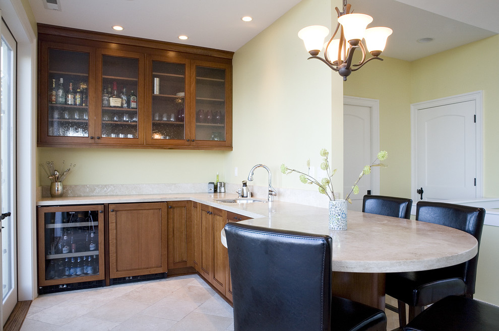 This is an example of a small traditional l-shaped wet bar in Seattle with an undermount sink, dark wood cabinets and ceramic floors.