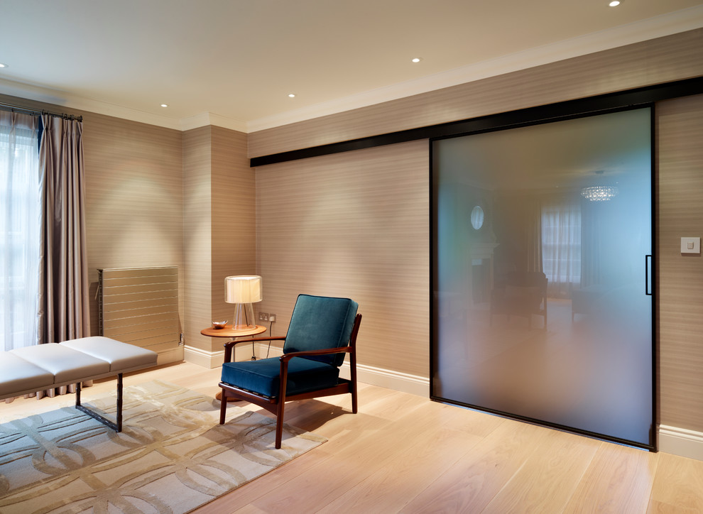 Photo of a large contemporary master bedroom in Surrey with light hardwood floors.