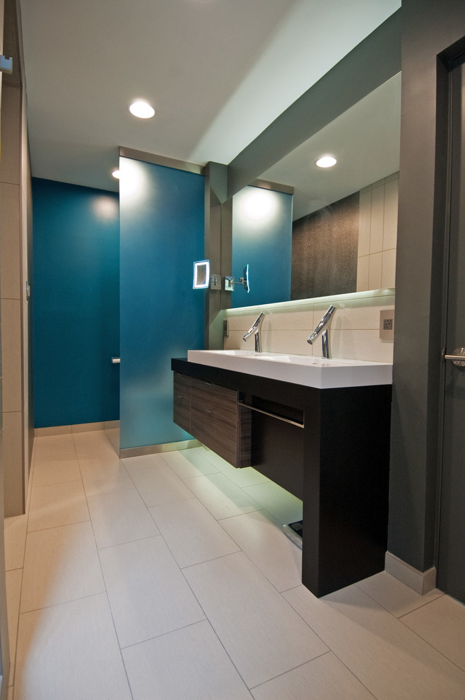 This is an example of a small modern master bathroom in Charlotte with a vessel sink, furniture-like cabinets, dark wood cabinets, a curbless shower, a one-piece toilet, gray tile, ceramic tile, grey walls and porcelain floors.