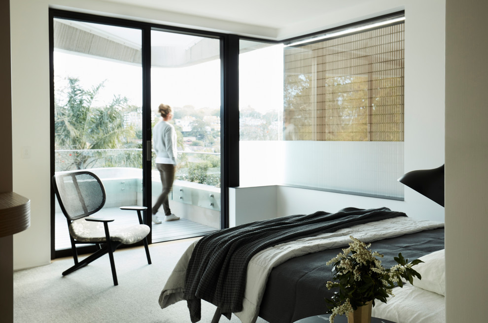 This is an example of a modern bedroom in Sydney with white walls and white floor.
