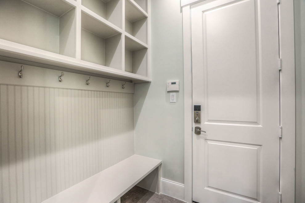 Example of a mid-sized transitional mudroom design in Houston with a white front door