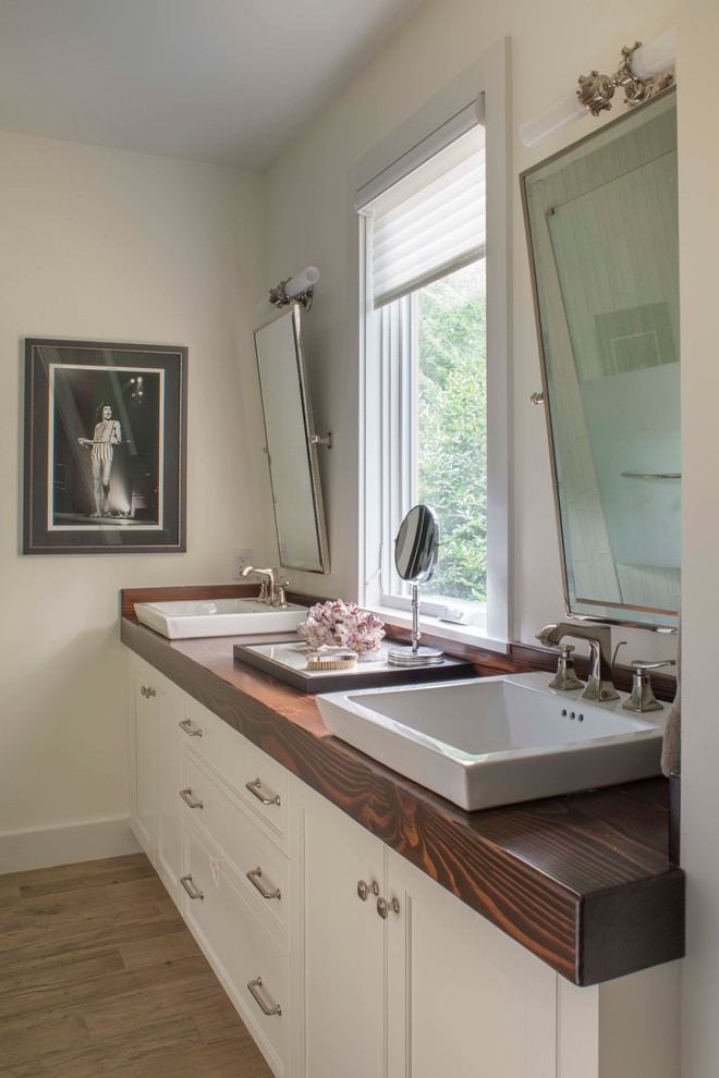 Mid-sized transitional 3/4 bathroom in DC Metro with beaded inset cabinets, white cabinets, a corner shower, beige walls, porcelain floors, a vessel sink and wood benchtops.