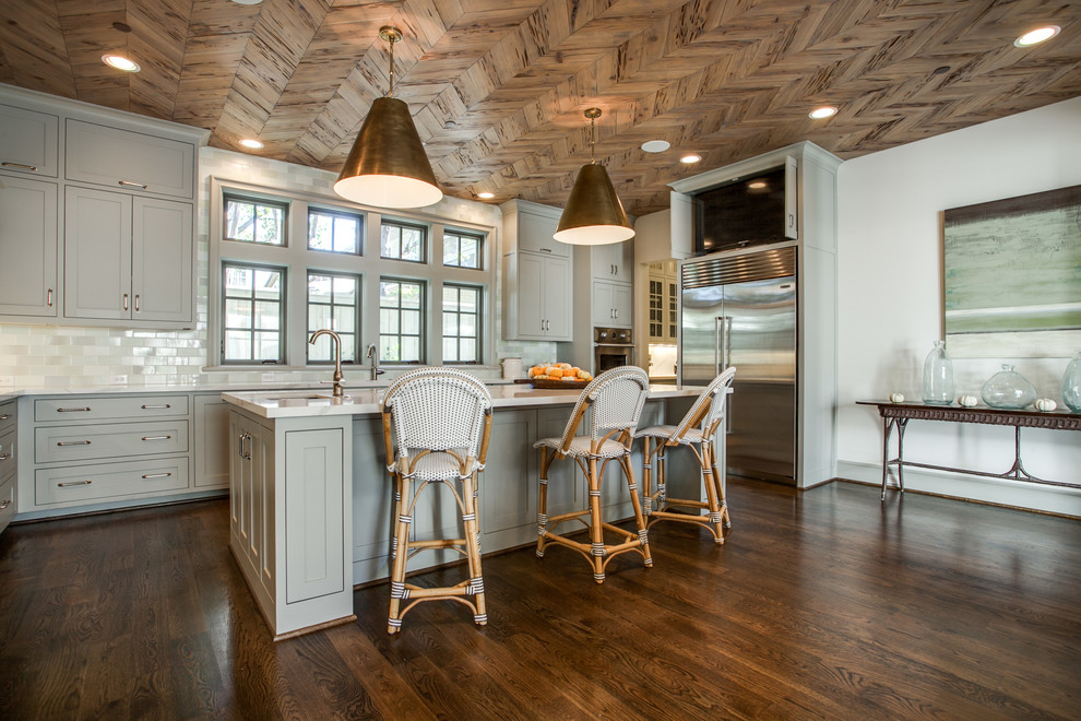 Transitional kitchen photo in Dallas with recessed-panel cabinets, gray cabinets, gray backsplash, subway tile backsplash and stainless steel appliances