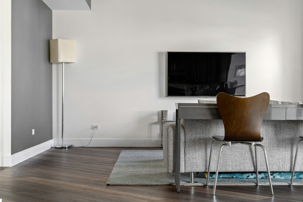 Diseño de salón abierto bohemio grande con paredes multicolor, suelo vinílico, televisor colgado en la pared y suelo gris