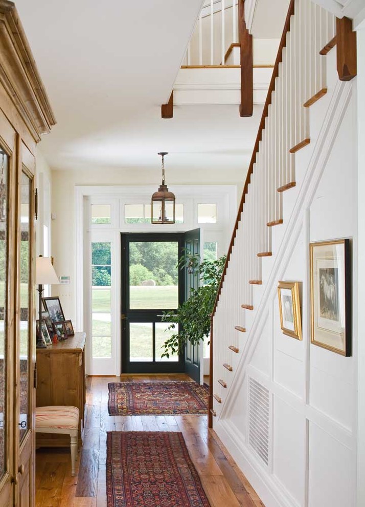 Design ideas for a traditional entryway in DC Metro with white walls, a single front door and a black front door.
