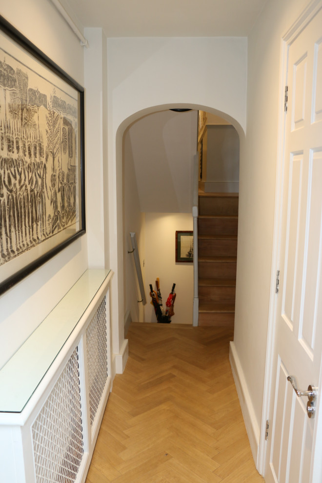 Design ideas for a large eclectic hallway in London with light hardwood floors.