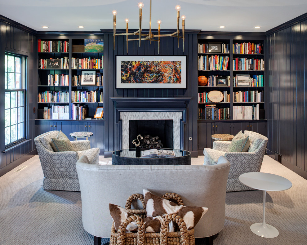 This is an example of a transitional living room in Chicago with a library, blue walls, carpet, a standard fireplace, a tile fireplace surround and no tv.