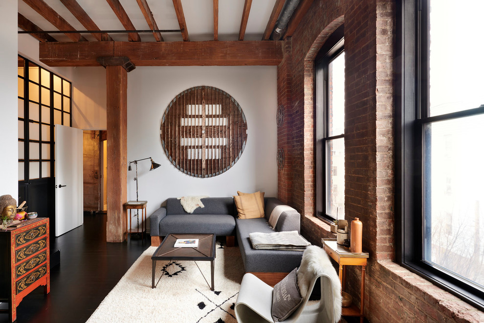 Photo of an industrial living room in Other with white walls, dark hardwood floors and black floor.