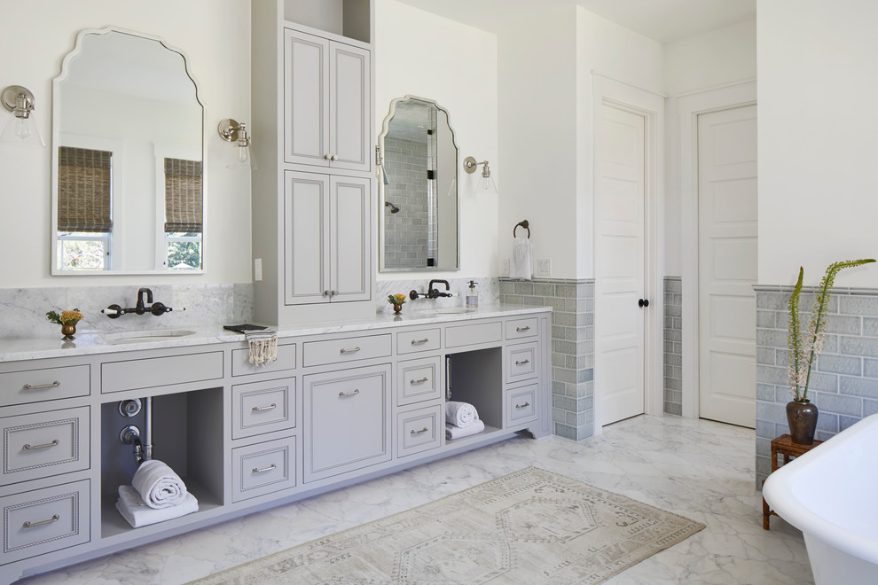 Expansive beach style master bathroom in Austin with grey cabinets, subway tile, marble benchtops, white benchtops, white walls, marble floors, an undermount sink, white floor and recessed-panel cabinets.