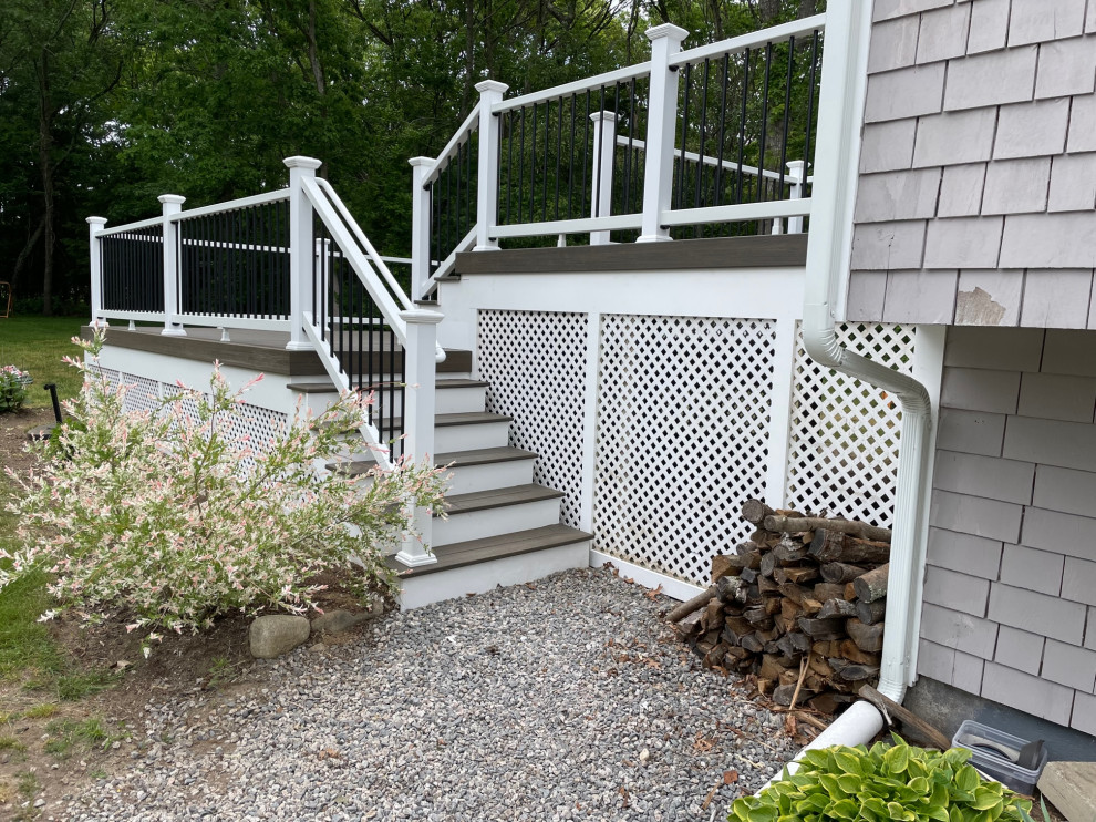 Deck - large transitional side yard second story mixed material railing deck idea in Providence
