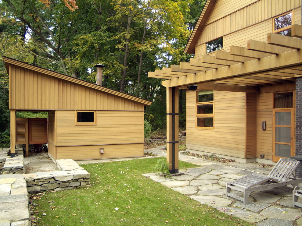 Inspiration for a large country two-storey beige house exterior in Burlington with wood siding.
