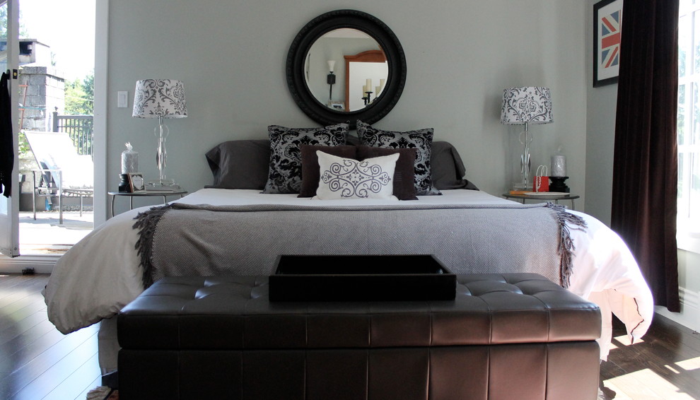 Inspiration for a mid-sized traditional master bedroom in Vancouver with grey walls and medium hardwood floors.
