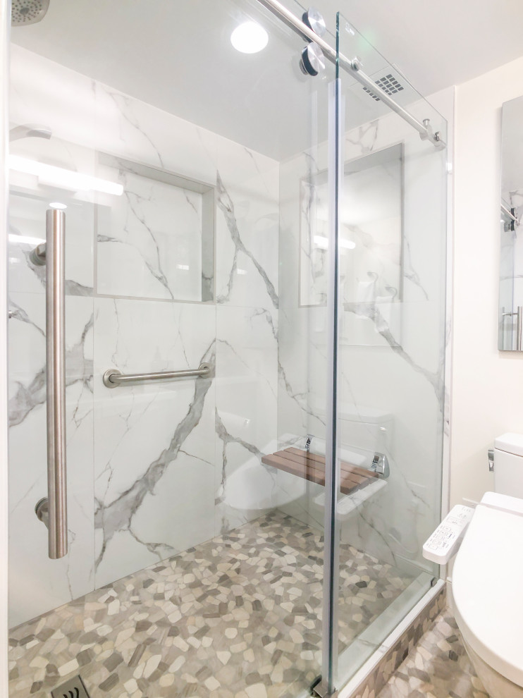 Photo of a small modern master bathroom in DC Metro with flat-panel cabinets, brown cabinets, an alcove shower, a bidet, multi-coloured tile, ceramic tile, yellow walls, pebble tile floors, a pedestal sink, engineered quartz benchtops, multi-coloured floor, a sliding shower screen, white benchtops, a shower seat, a single vanity and a built-in vanity.