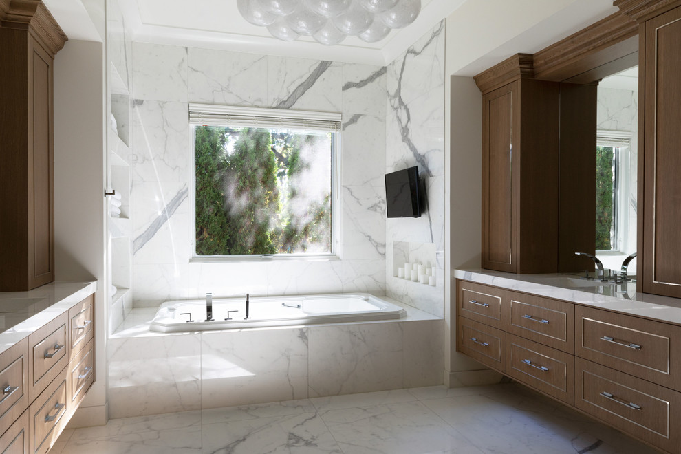 Large contemporary master bathroom in Chicago with beaded inset cabinets, light wood cabinets, a drop-in tub, a two-piece toilet, white tile, porcelain tile, multi-coloured walls, porcelain floors, an undermount sink, tile benchtops, multi-coloured floor and white benchtops.