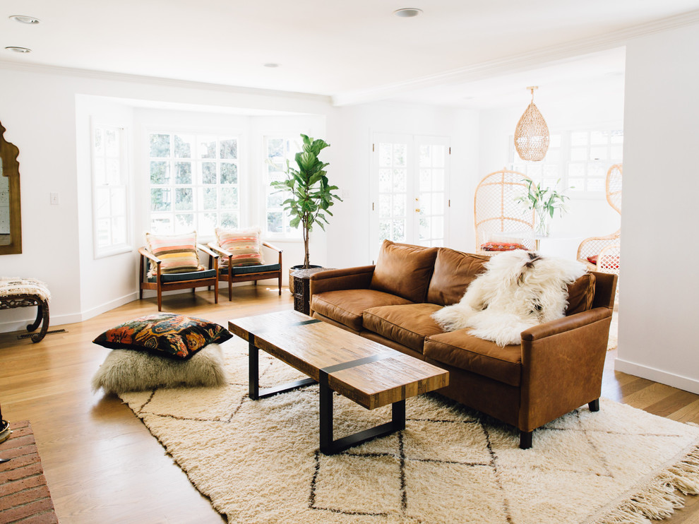 Scandinavian living room in Sacramento with white walls, medium hardwood floors and no fireplace.