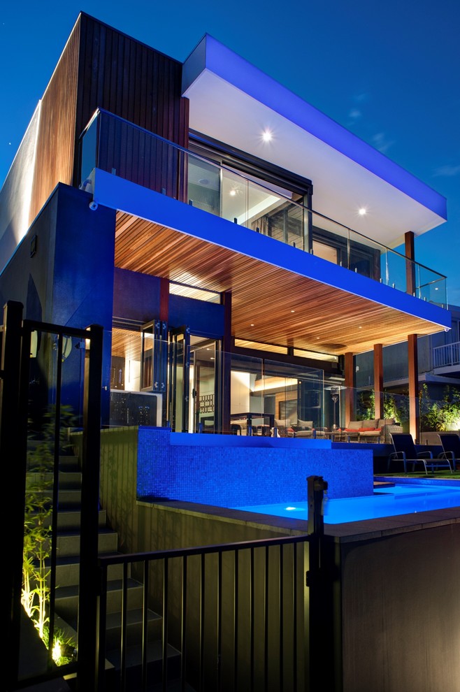 Inspiration for a large contemporary two-storey exterior in Gold Coast - Tweed with wood siding.