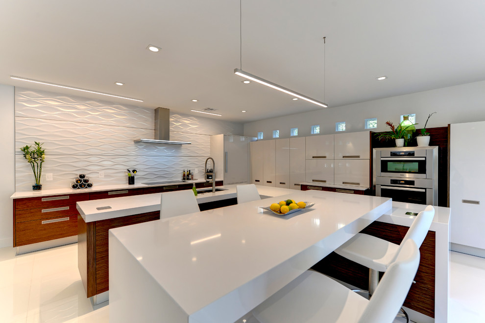 This is an example of a large contemporary l-shaped eat-in kitchen in Other with flat-panel cabinets, medium wood cabinets, solid surface benchtops, white splashback, stainless steel appliances, ceramic floors, a peninsula and white floor.