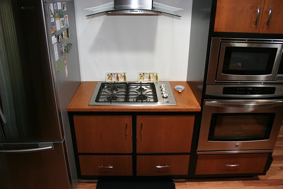 Mid-sized transitional medium tone wood floor kitchen photo in Phoenix with flat-panel cabinets, medium tone wood cabinets, wood countertops and stainless steel appliances