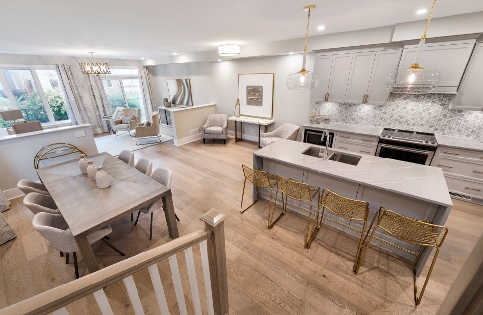 Mid-sized transitional l-shaped light wood floor and brown floor kitchen photo in Ottawa with an undermount sink, recessed-panel cabinets, gray cabinets, quartz countertops, gray backsplash, mosaic tile backsplash, stainless steel appliances, an island and gray countertops