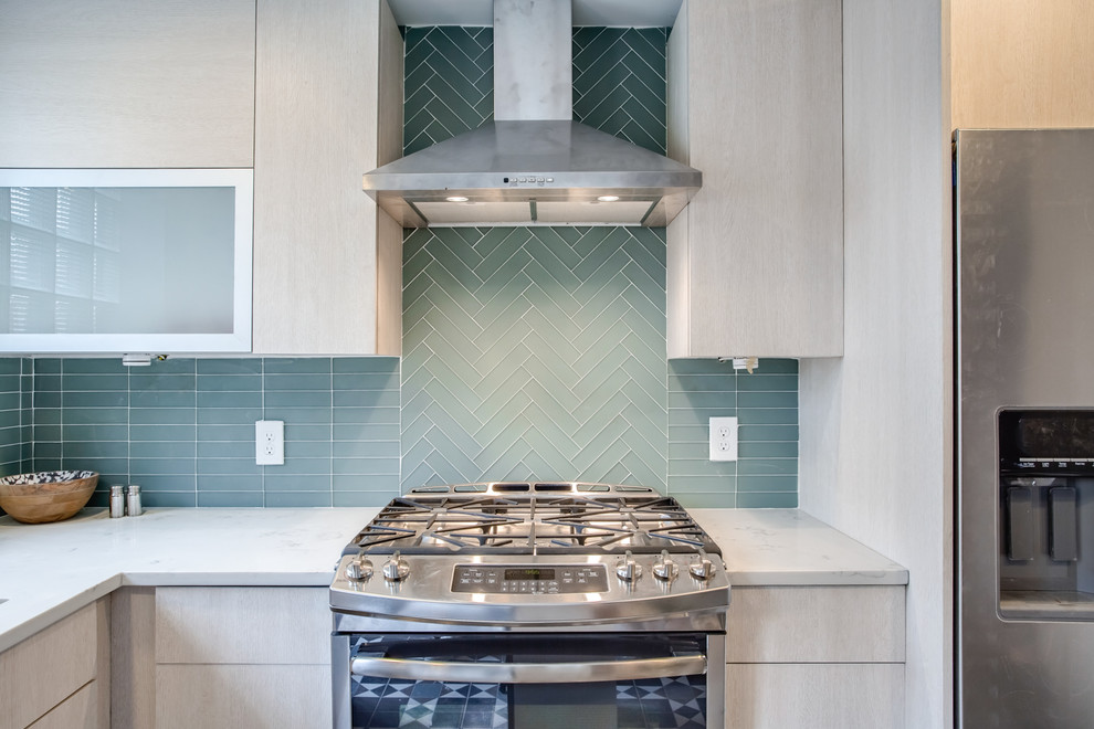 Photo of a small midcentury l-shaped separate kitchen in Philadelphia with an undermount sink, flat-panel cabinets, beige cabinets, quartz benchtops, blue splashback, glass tile splashback, stainless steel appliances, ceramic floors, with island and multi-coloured floor.