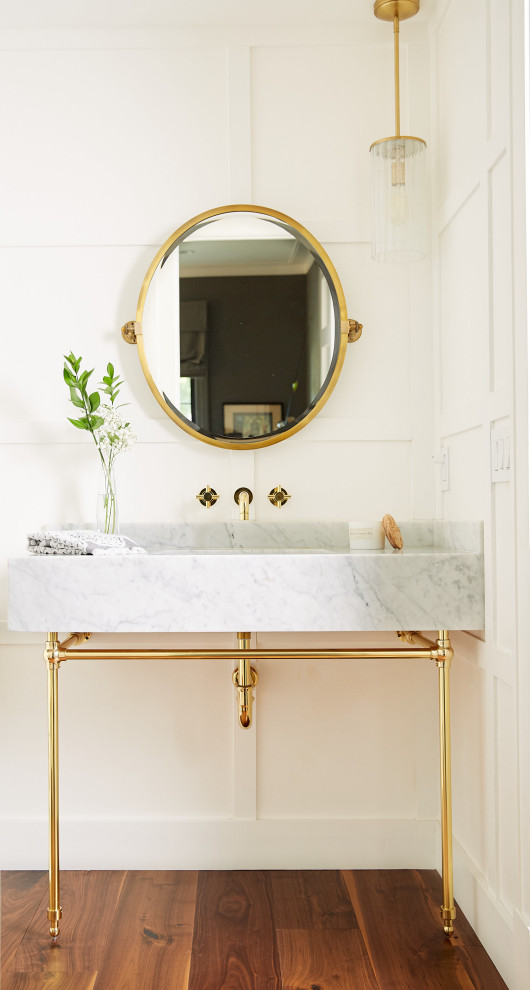 Medium sized traditional cloakroom in Orange County with white walls, medium hardwood flooring, a submerged sink, marble worktops, brown floors, white worktops and a built in vanity unit.