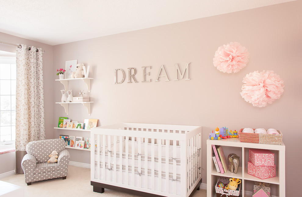 Transitional nursery in Toronto with pink walls, carpet and beige floor for girls.