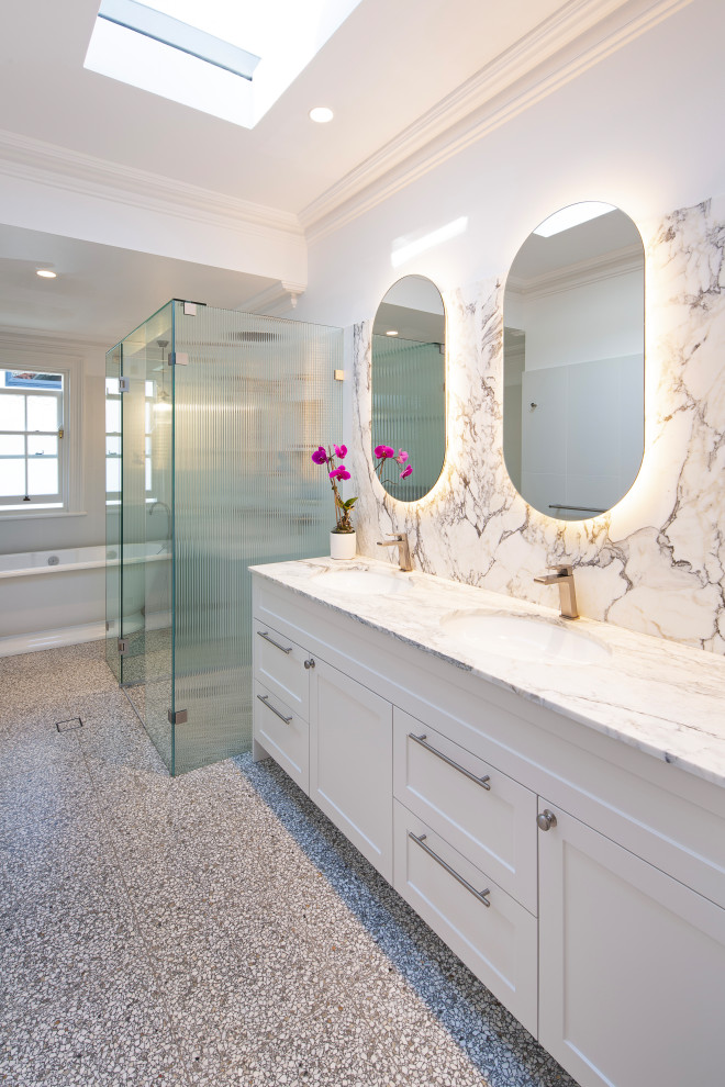 Design ideas for a large bathroom in Sydney with shaker cabinets, yellow cabinets, a freestanding tub, a one-piece toilet, white tile, porcelain tile, white walls, terrazzo floors, an undermount sink, marble benchtops, grey floor, a hinged shower door, a double vanity, a built-in vanity and white benchtops.