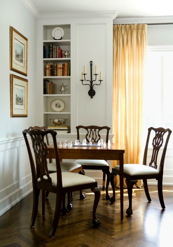 Photo of a traditional dining room in Raleigh with white walls and dark hardwood floors.