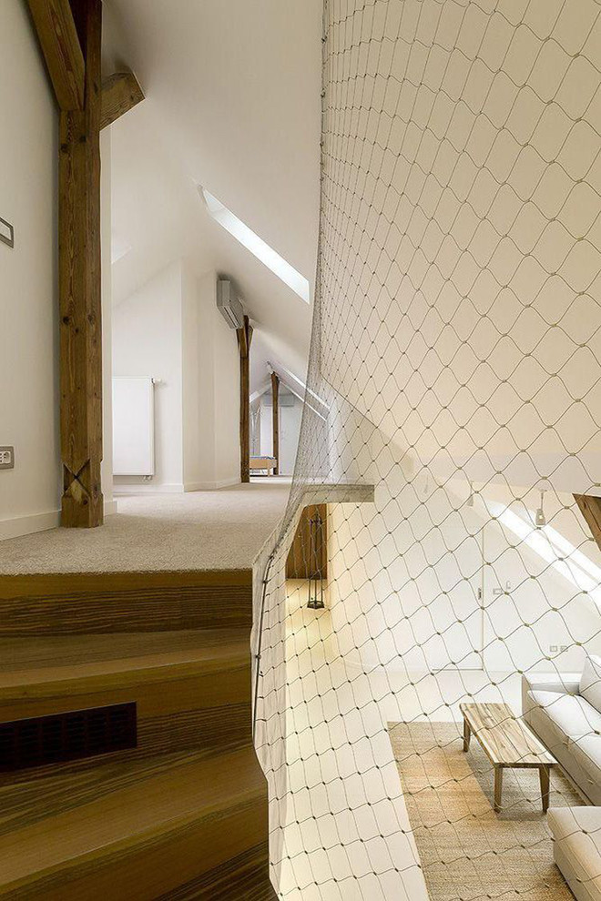 Mid-sized modern wood curved staircase in Paris with wood risers.