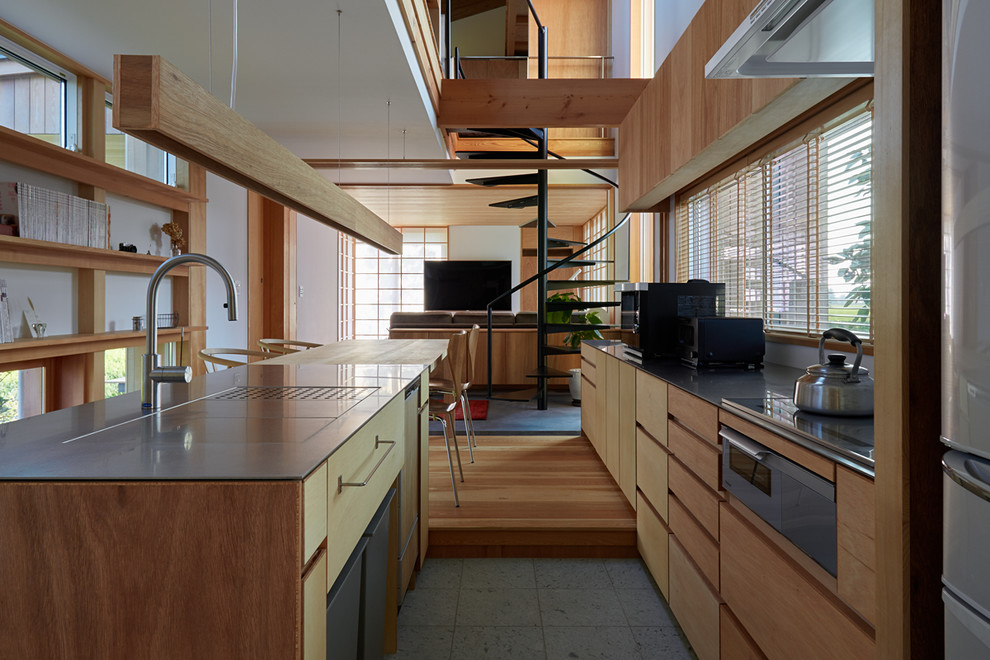 Asian galley open plan kitchen in Other with a single-bowl sink, flat-panel cabinets, brown cabinets, stainless steel benchtops, with island, grey floor and brown benchtop.