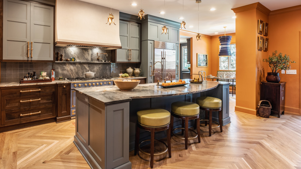 Photo of a large traditional single-wall separate kitchen in Indianapolis with a farmhouse sink, recessed-panel cabinets, blue cabinets, quartzite benchtops, blue splashback, stone tile splashback, coloured appliances, light hardwood floors, with island, beige floor and blue benchtop.