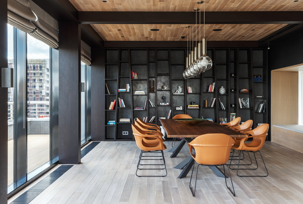 Large contemporary separate dining room in Moscow with light hardwood floors, beige floor and black walls.