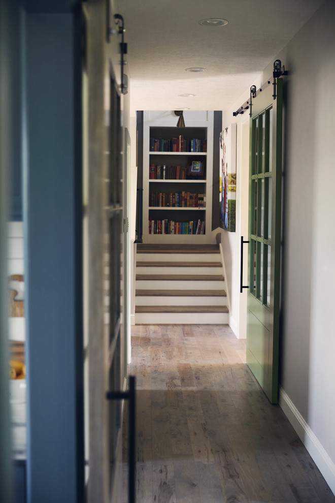 Inspiration for a mid-sized rustic light wood floor hallway remodel with white walls